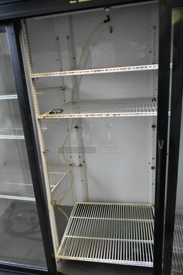True GDM-69 metal commercial cooler with three glass doors and poly-coated racks. Operates on 115 volts, 1 phase.