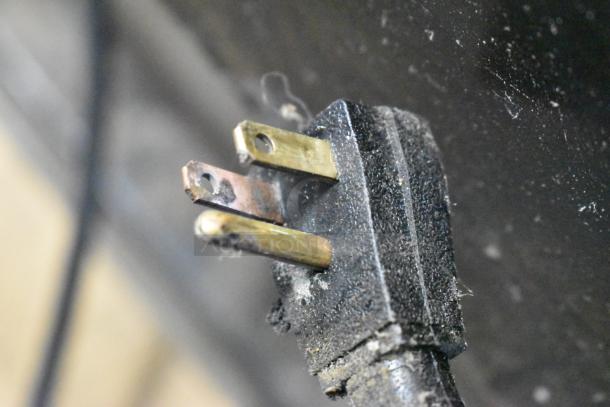 Close-up of a worn power plug for the True GDM-69 cooler. Shows signs of use and potential need for replacement.
