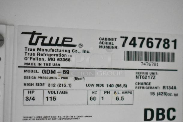 True GDM-69 metal 3-door reach-in cooler with poly-coated racks, 115 volts, model GDM-69, serial 7476781.