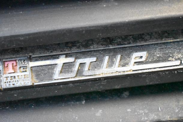 True GDM-69 cooler label, featuring the brand's logo and manufacturing details. Visible wear indicates usage.