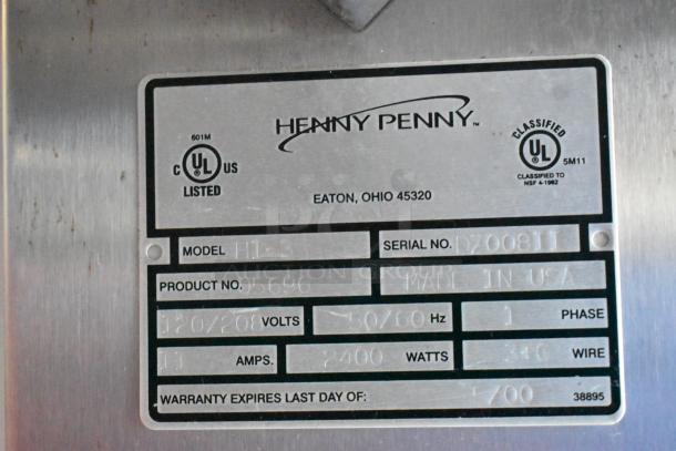 Henny Penny HI-3 heated display case label shows model, serial number, voltage, and amps. Made in USA, UL listed.