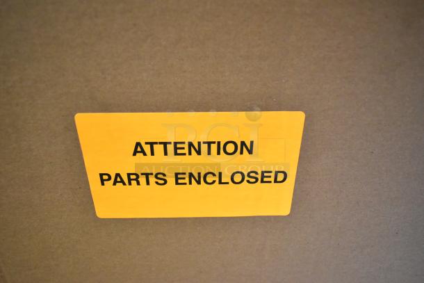 Cardboard box with yellow label reading "ATTENTION PARTS ENCLOSED" for Bunn DUAL SH DBC coffee machine packaging.
