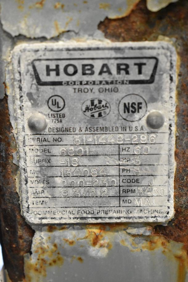 Hobart 6801 Meat Saw label, showing model, voltage (200-230V, 3 phase), amps, and serial number. Rust visible on surface.