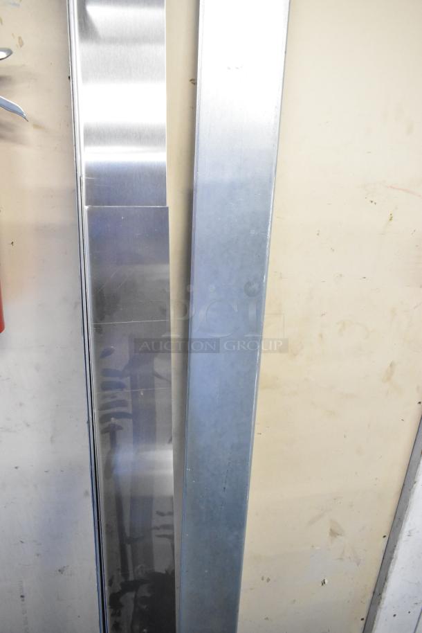 Two vertical metal panels, one shiny and reflective, the other matte. In excellent condition, ideal for industrial use.