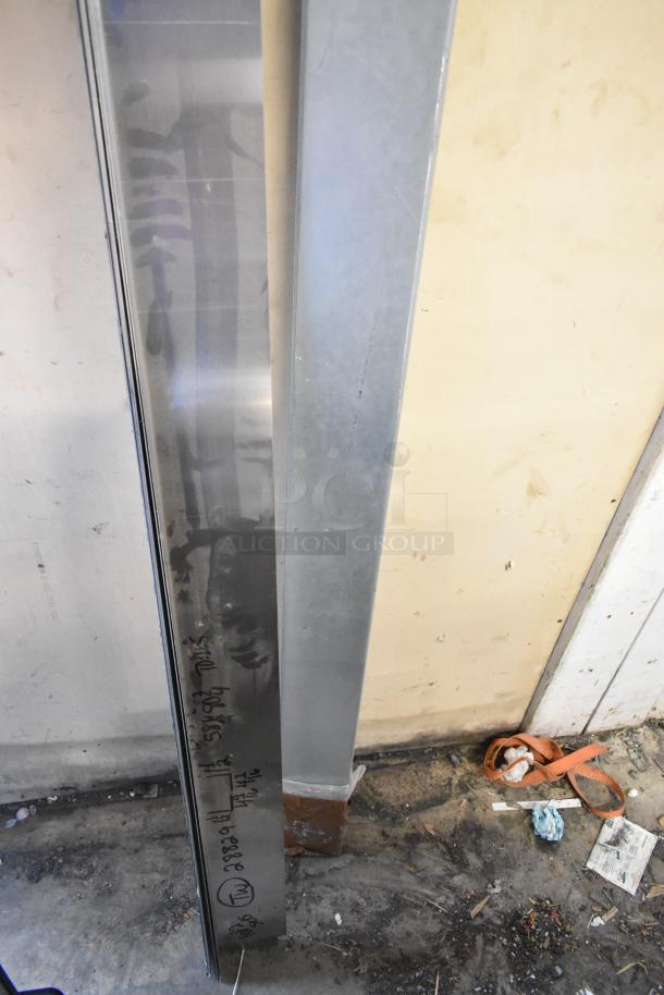 Two metal panels, tall and rectangular, in good condition. One panel has handwritten markings; other is plain. Suitable for construction.