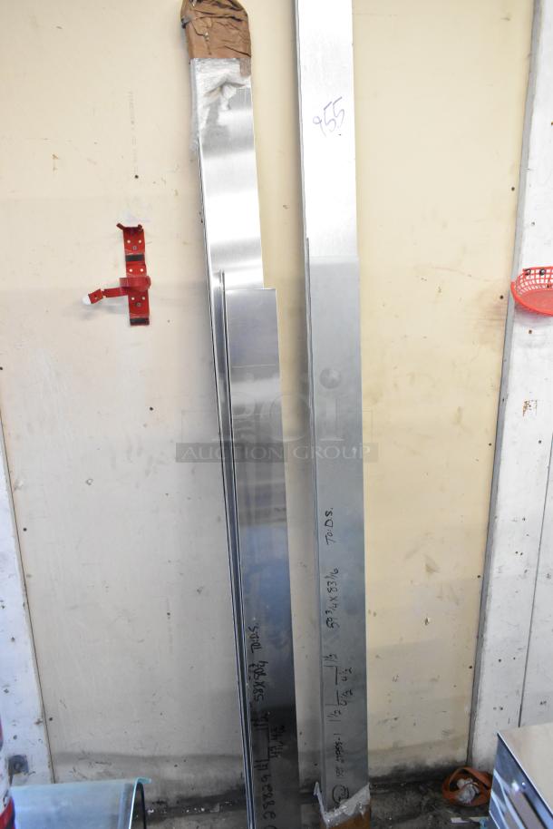 Two metal panels stand upright against a wall. Panels have markings and paper wrapping at one end. Good condition.