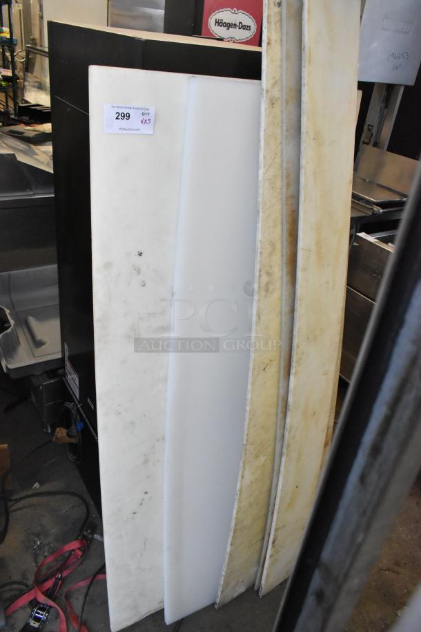 Five various cutting boards in mixed condition, featuring wear marks. Auction label indicates quantity of five, amplifying bid value.