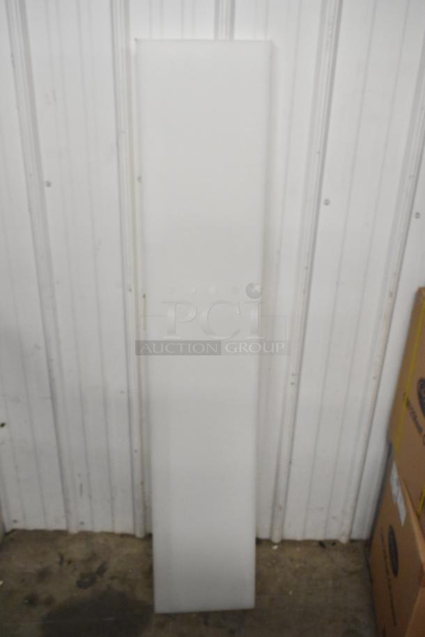 Five various cutting boards in pristine condition, stacked vertically. Durable material suitable for kitchen use.