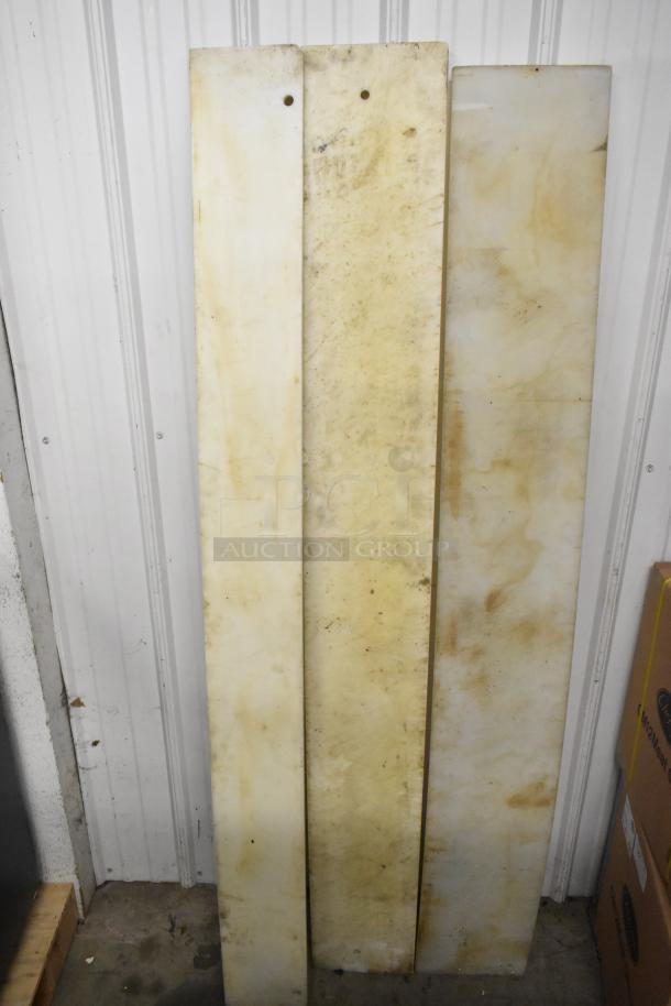 Five varied cutting boards with signs of wear, featuring a rectangular shape and beige coloration. Suitable for auction bidding.