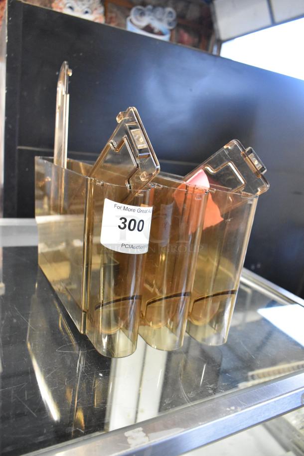 Amber-colored poly hoppers, set of 3, showing auction label “300”, clear sturdy design, excellent condition for bidding.