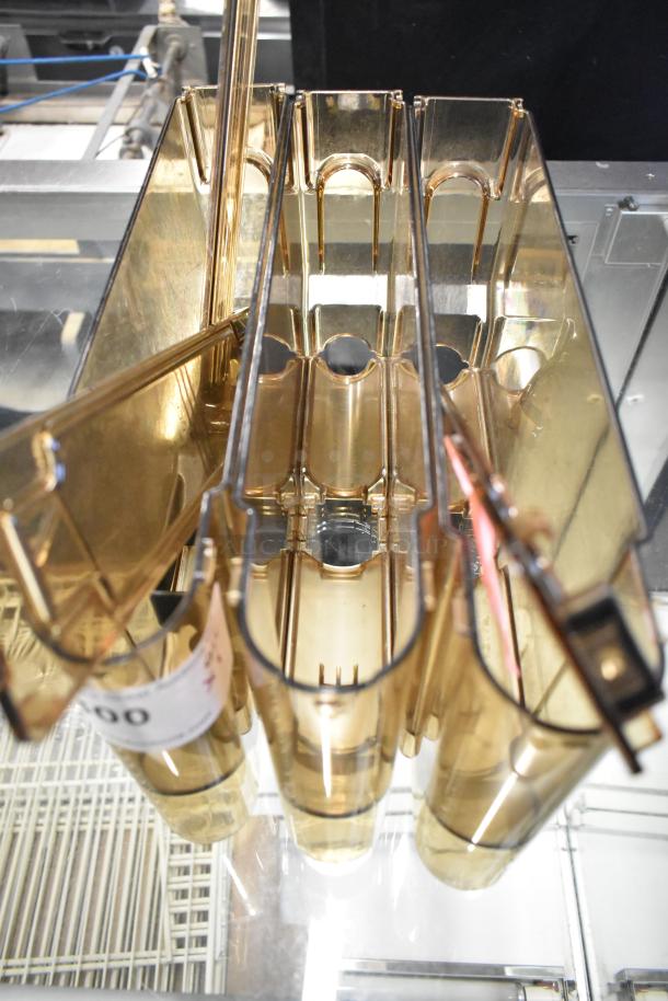 Three amber colored poly hoppers, shown vertically. Each hopper is transparent, showcasing clean, smooth surfaces.