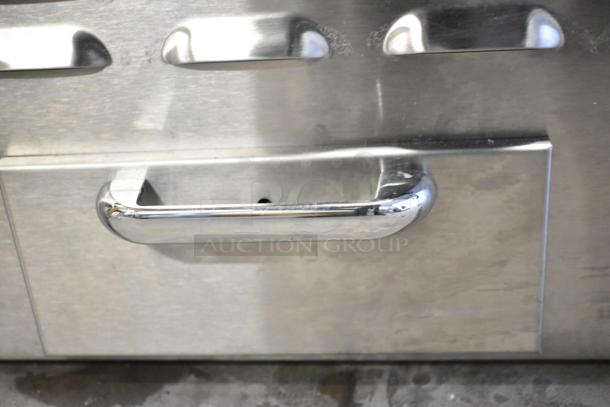 Stainless steel Wells 5G-G19-208 electric griddle, 36" new with minor scratches. Features durable handle. Powered at 208 volts.