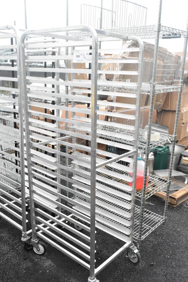 Two metal commercial pan transport racks on casters, sturdy frame, multiple shelves, ideal for bakery or kitchen use.