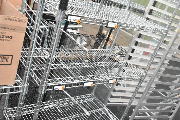 Chrome finish 4-tier wire shelving unit, robust construction. Buyer must dismantle. Includes labeled shelves. Consider freight.