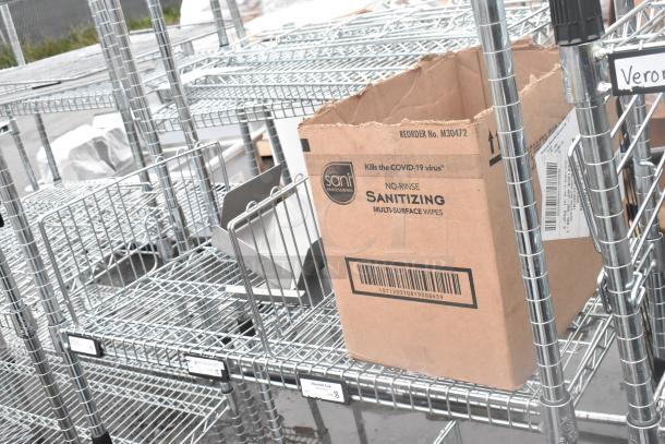 Chrome 4-tier wire shelving unit, sturdy metal construction, includes label tags. Buyer must dismantle for shipping.