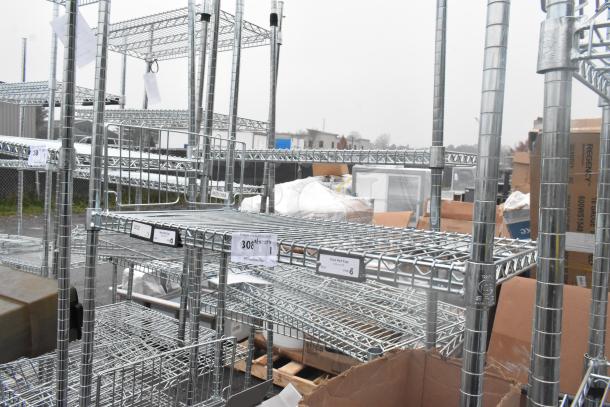 Chrome finish 4 tier wire shelving unit. Includes visible labels and markings. Buyer must dismantle for shipping.