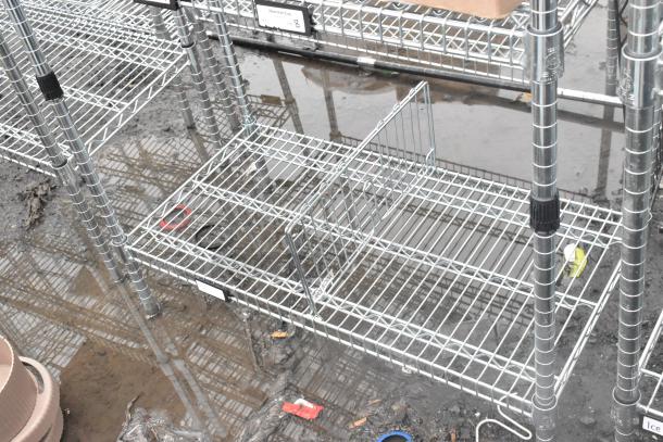 Chrome finish 4-tier wire shelving unit, in used condition. Buyer must dismantle. Note potential freight charges.