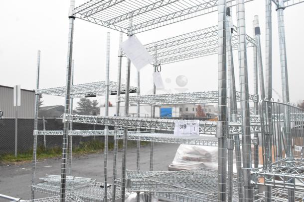 Chrome finish 4-tier wire shelving unit in good condition. Buyer must dismantle. Freight charges apply. Tags indicate "309."