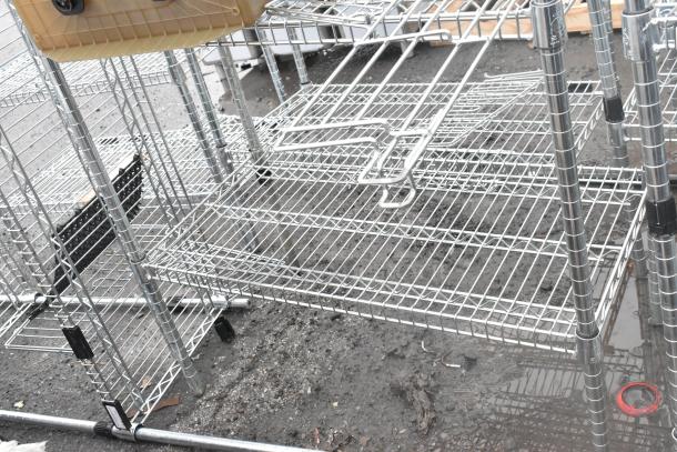 Chrome finish 4-tier wire shelving unit, in good condition, requires buyer dismantling. Consider freight charges.