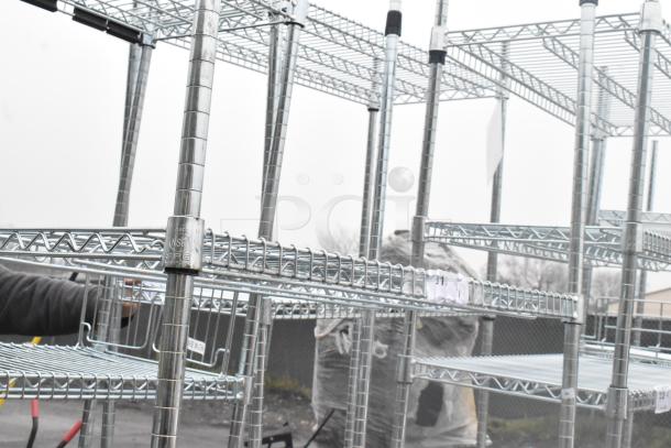 Chrome finish 4-tier wire shelving unit. Sturdy design, requires buyer dismantling. Consider freight for shipping.