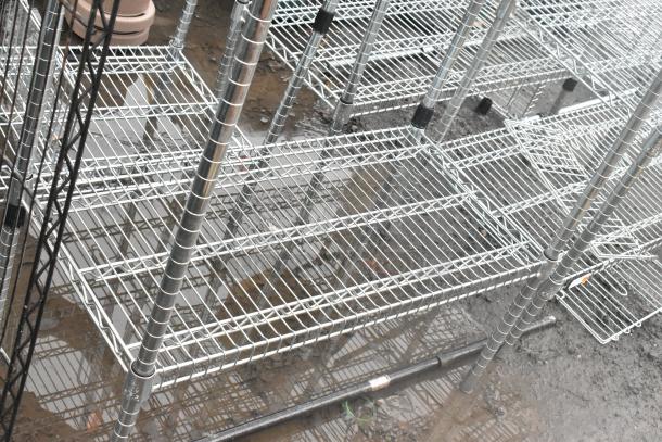 Chrome finish 4-tier wire shelving unit, sturdy design, outdoor setting. Buyer must dismantle. Consider freight charges.