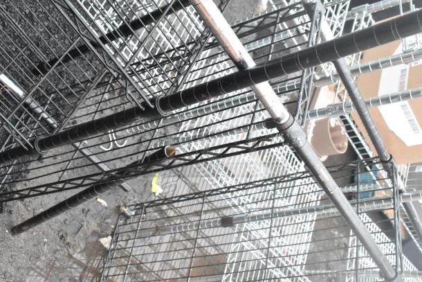 Two black finish wire shelving units, used condition, requiring buyer disassembly. Freight shipping advised.