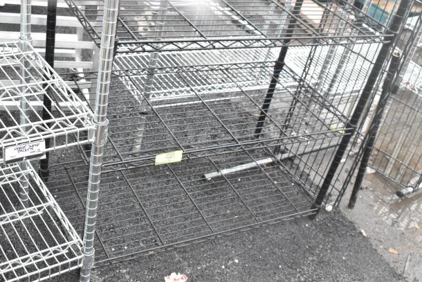 Two black finish wire shelving units, disassembled, sturdy design, multiple tiers. Buyer must dismantle for shipping.