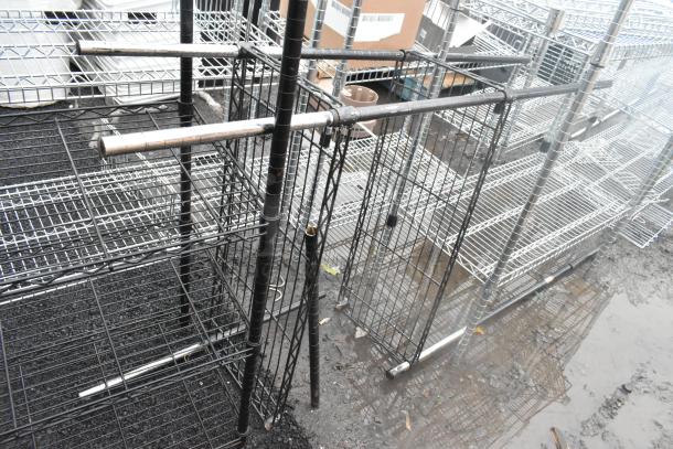 Two black wire shelving units, assembled, visible wear. Buyer must dismantle. Consider freight shipping costs.