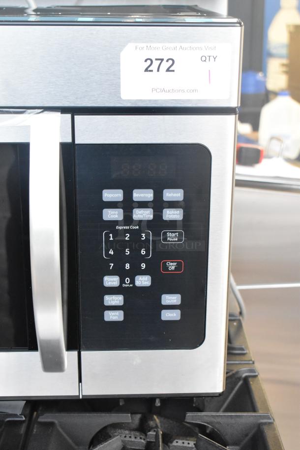 BRAND NEW Scratch and Dent KoolMore KM-MOT-1SS Stainless Steel Microwave Oven, digital controls, 120V, auction tag visible.