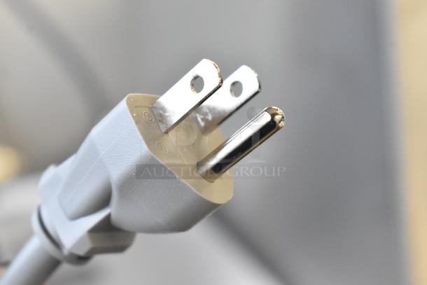 Close-up of a power plug, likely for KoolMore KM-MOT-1SS stainless steel microwave oven, 120 volts, 1 phase.