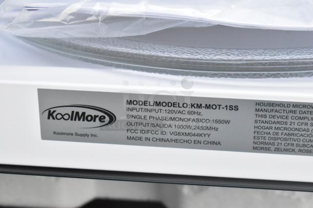 Brand new KoolMore KM-MOT-1SS stainless steel microwave, scratch and dent, 120V, 1 phase, with plate. Label indicates model and input details.