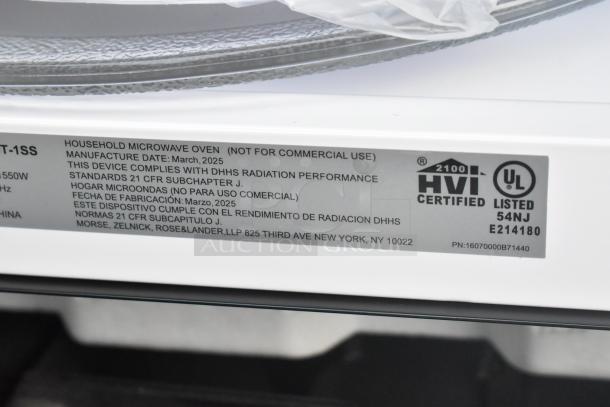 KoolMore KM-MOT-1SS stainless steel microwave, brand new with minor scratches, 120V, showing specification label.