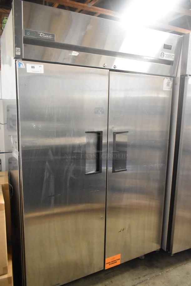 True TG2R-2S-HC stainless steel 2-door reach-in cooler with poly-coated racks. Needs door reattachment. 115V, 1 phase.