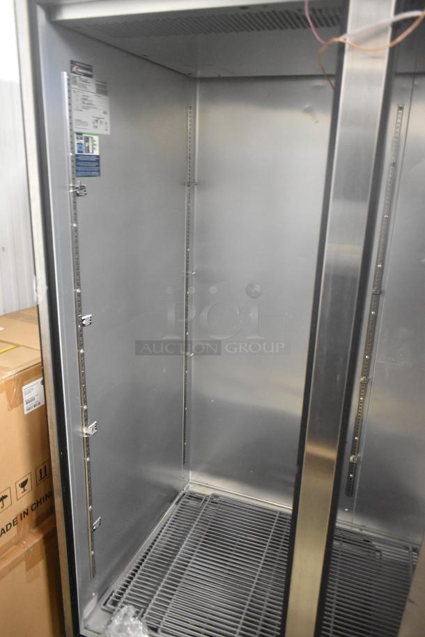 2024 True TG2R-2S-HC stainless steel 2-door reach-in cooler, poly-coated racks, door needs reattachment, 115V, 1 phase.