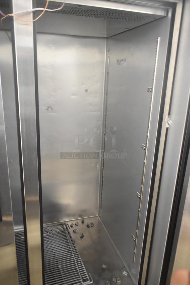 2024 True TG2R-2S-HC commercial cooler, stainless steel, 2 doors, poly coated racks, door reattachment needed, 115V, 1 phase.