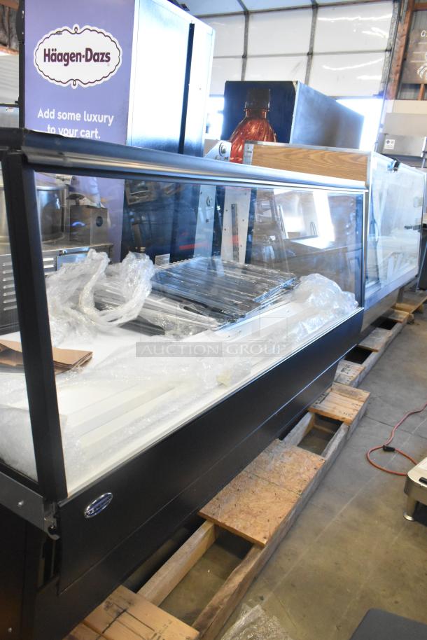 Federal metal floor-style merchandiser display case, features clear glass front, good condition, Häagen-Dazs branding visible.