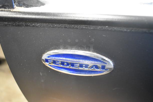 Federal Metal Floor Merchandiser Display Case, features metal construction, Federal logo badge, good condition.