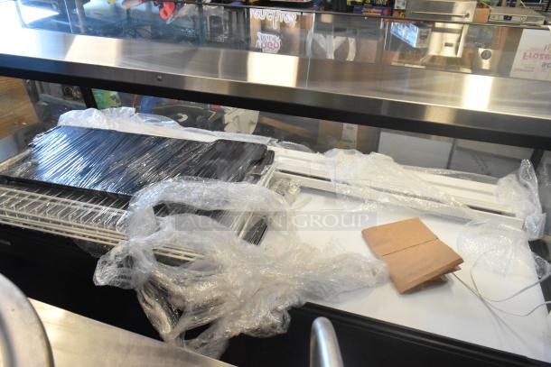 Federal Metal Floor Style Merchandiser Display Case; glass and metal construction; wrapped in protective plastic; unused condition.