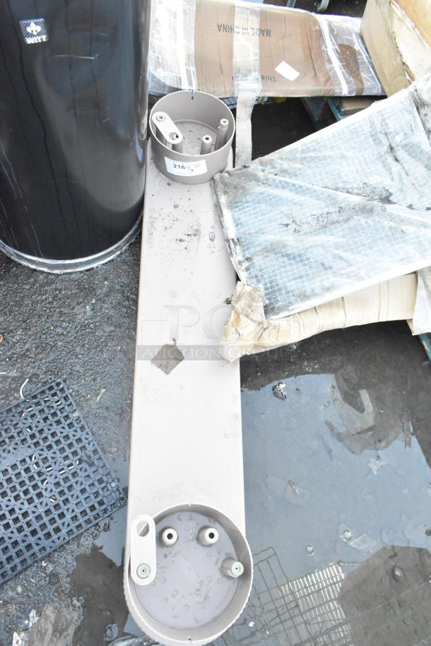 Two Poly units on pavement, marked "218," showing minor wear and signs of outdoor exposure.