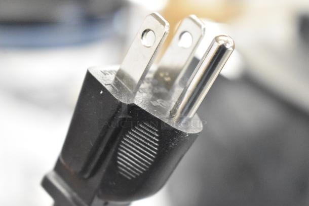 Close-up of a standard three-prong electrical plug connected to an AvaMix 928BX1100P commercial blender, model 2024.