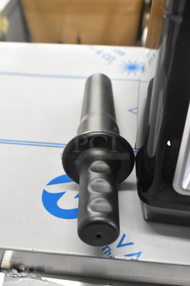 AvaMix 928BX1100P blender tamper, black plastic, shown beside blender base.