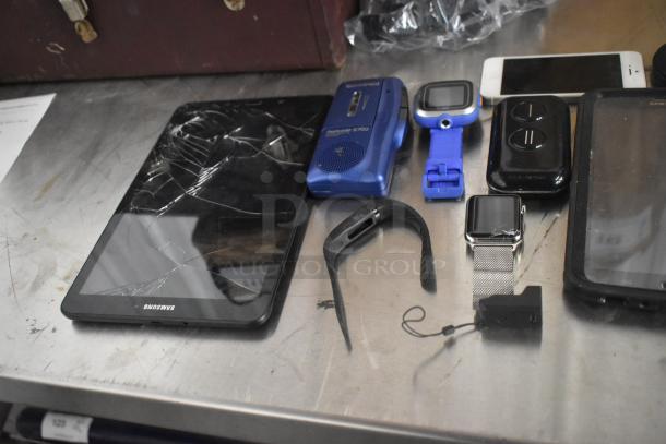 Basket of 22 items, including cracked Samsung tablet, portable player, watches, and phones. Various conditions.