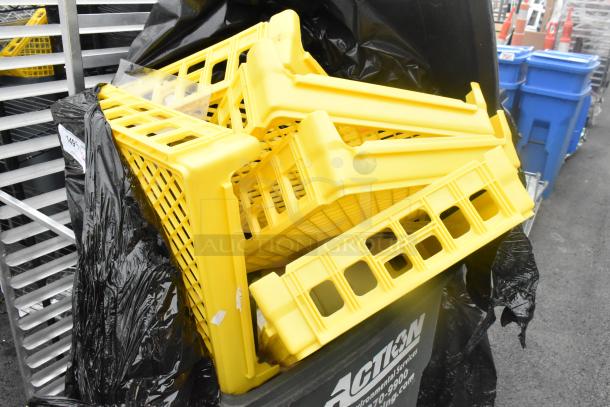 Poly trash can filled with yellow bread caddies, showing moderate wear, with visible brand markings on the trash can.