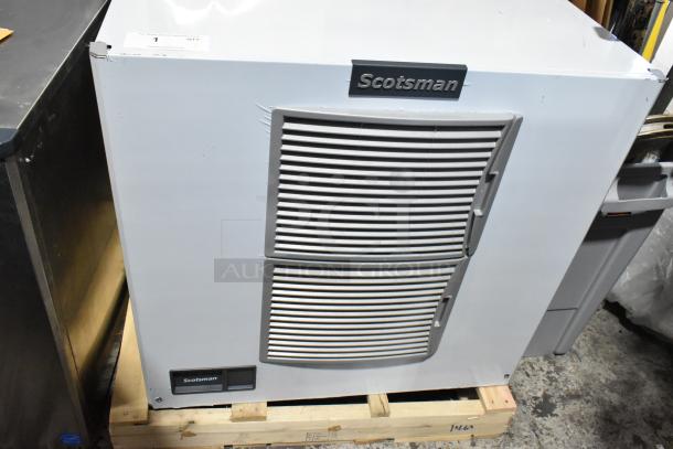 Brand new Scotsman MC1030MA-32A ice machine, stainless steel, medium cube, 1077 lb capacity, slight dents visible.