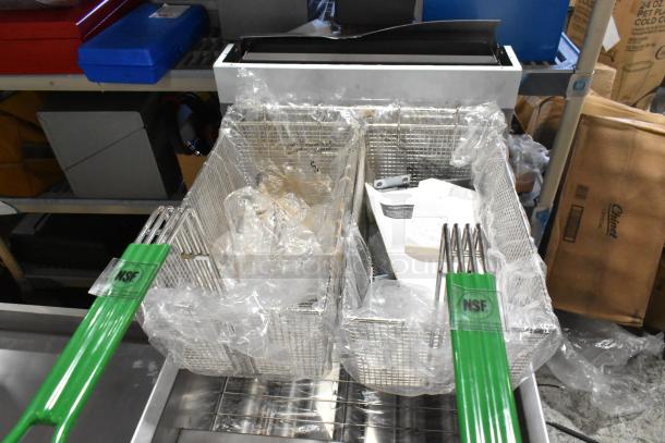 Brand new Dean SR162GN stainless steel gas fryer, 75 lb capacity, with NSF-certified green-handled metal baskets.
