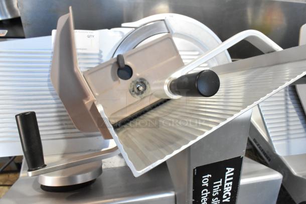 Bizerba SE 12 US metal commercial meat slicer with blade sharpener, on stainless steel stand. 120V, 1 Phase.