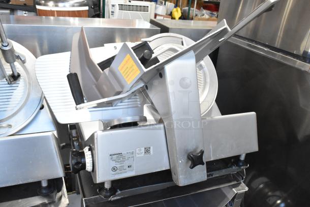 Bizerba SE 12 US commercial meat slicer with blade sharpener, stainless steel, on equipment stand. 120V, 1 phase.