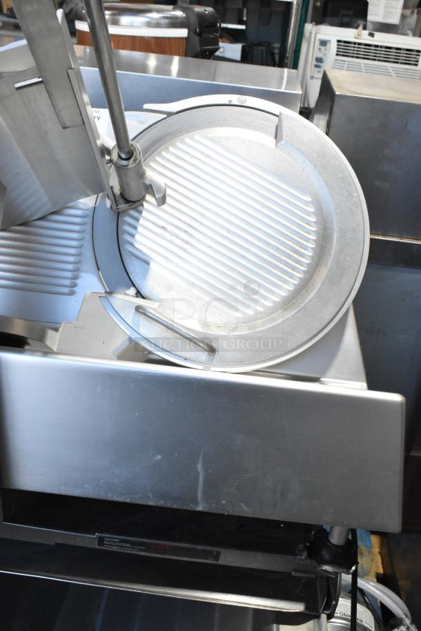 Bizerba SE 12 US metal meat slicer with blade sharpener on stainless stand; commercial, 120V, 1 phase, excellent condition.