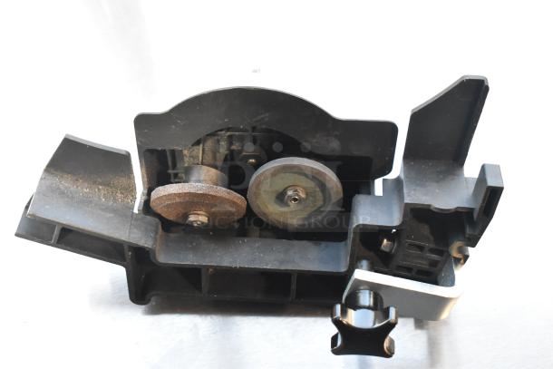 Bizerba SE 12 US meat slicer blade sharpener component, showing grinding wheels and adjustment knob, used condition.