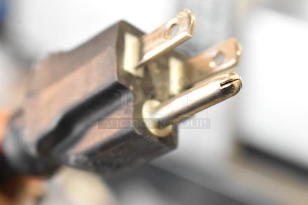 Close-up of a metal prong plug, part of the Bizerba SE 12 US commercial meat slicer. Compatible with 120 Volts, 1 Phase.